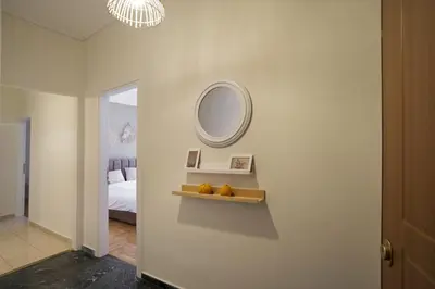 a white room with a mirror and a bed at Pinelopi Spotless 2 BR Renovated Apt Athens Center in Athens
