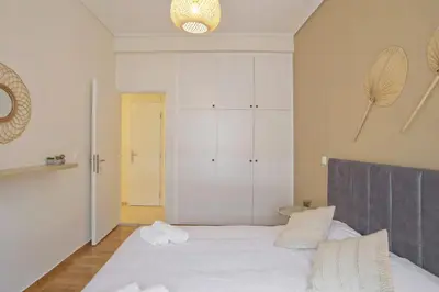 a bedroom with a white bed and a closet at Pinelopi Spotless 2 BR Renovated Apt Athens Center in Athens
