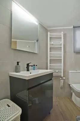 a bathroom with a sink and a toilet at Pinelopi Spotless 2 BR Renovated Apt Athens Center in Athens