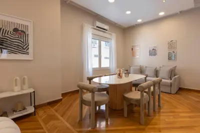 a dining room with a table and chairs at Kallirois Avenue House 7ppl 2BR Acropolis Metro Plaka 300m in Athens