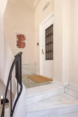 a hallway with white walls and a black door at Kallirois Avenue House 7ppl 2BR Acropolis Metro Plaka 300m in Athens