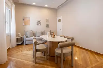 a living room with a table and chairs and a couch at Kallirois Avenue House 7ppl 2BR Acropolis Metro Plaka 300m in Athens
