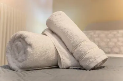 a rolled up towel on top of a bed at Penthouse with Acropolis view in Attiki Metro in Athens