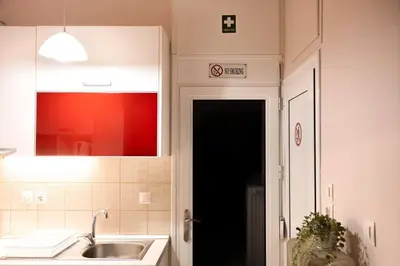 a kitchen with a sink and a black door at Penthouse with Acropolis view in Attiki Metro in Athens