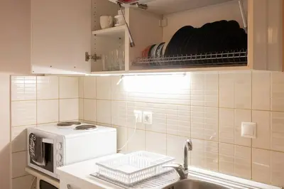 a kitchen with a sink and a microwave at Penthouse with Acropolis view in Attiki Metro in Athens