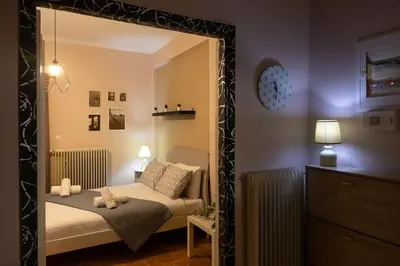 a bedroom with a bed and a large mirror at Penthouse with Acropolis view in Attiki Metro in Athens