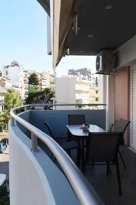 a balcony with a table and chairs on a roof at Enjoy The Athens Riviera! in Athens