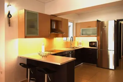 a kitchen with a counter and a refrigerator at Enjoy The Athens Riviera! in Athens