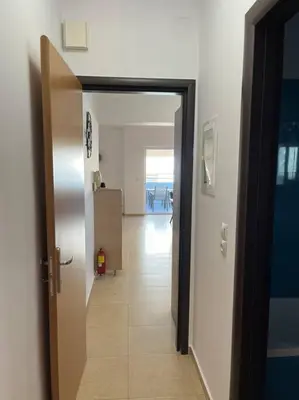a hallway with an open door to a room at Enjoy The Athens Riviera! in Athens