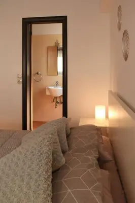 a bedroom with a bed and a sink and a mirror at Enjoy The Athens Riviera! in Athens