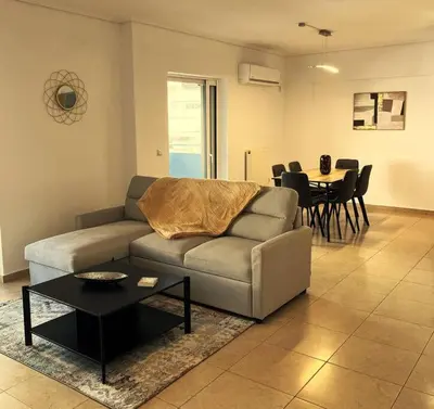 a living room with a couch and a table at Enjoy The Athens Riviera! in Athens