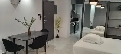 a room with a table and chairs and a bed at Luxury Semi-Basement Suite Athens in Athens