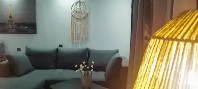 a living room with a couch and a vase on a table at Luxury Semi-Basement Suite Athens in Athens