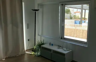 a bathroom with a sink and a window at Al Fresco Voula Apartment in Athens