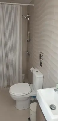 a white bathroom with a toilet and a sink at Al Fresco Voula Apartment in Athens