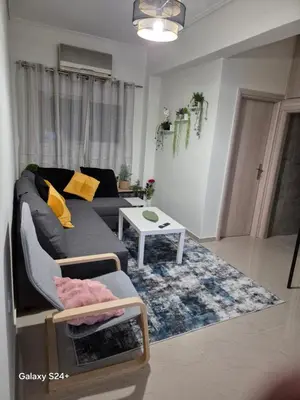 a living room with a couch and a table at Lavender-Dalia cosy apartment center of Athens in Athens