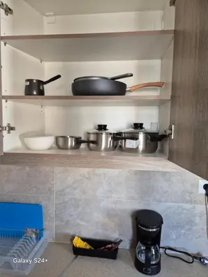a kitchen with pots and pans on the shelves at Lavender-Dalia cosy apartment center of Athens in Athens