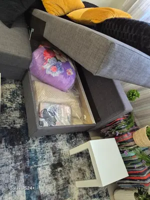 a box with a pillow on the floor next to a couch at Lavender-Dalia cosy apartment center of Athens in Athens