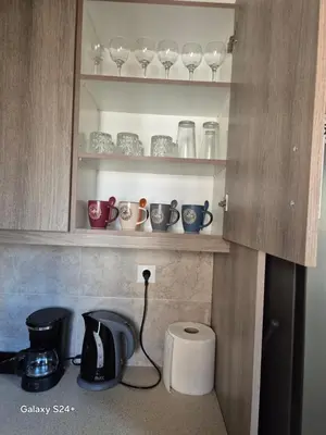 a kitchen with a coffee maker and cups on a shelf at Lavender-Dalia cosy apartment center of Athens in Athens