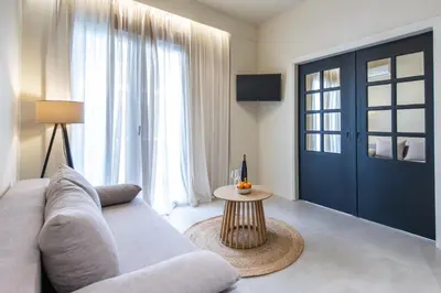 a living room with a couch and a table at AVM Suites - Athens Thissio Center in Athens