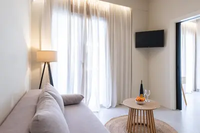 a living room with a couch and a table at AVM Suites - Athens Thissio Center in Athens