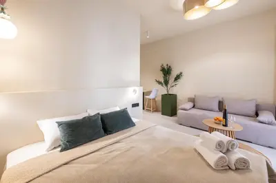 a bedroom with a large bed and a couch at AVM Suites - Athens Thissio Center in Athens