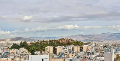 a view of a city with buildings and mountains at 2 BD Lycabettus Stylish Apartment by Live&Travel in Athens