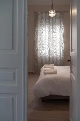 a bedroom with a bed with two towels on it at 1 BD Lycabettus Neoclassic House by Live&Travel in Athens