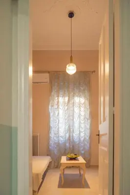 a room with a table in front of a window at 1 BD Lycabettus Neoclassic House by Live&Travel in Athens