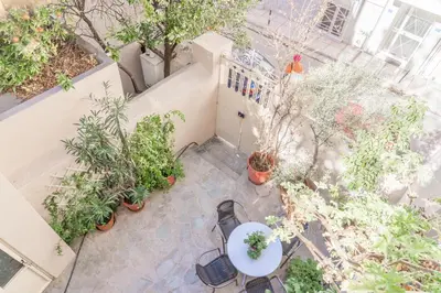 an overhead view of a patio with plants and a table at 1 BD Lycabettus Neoclassic House by Live&Travel in Athens