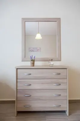 a dresser with a mirror on top of it at Sunny & Spacious 2BD apt near Acropolis in Athens