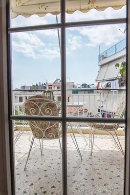 a window with a view of a ship at Sunny & Spacious 2BD apt near Acropolis in Athens