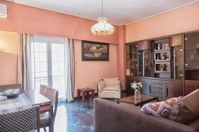 a living room with a couch and a table at Sunny & Spacious 2BD apt near Acropolis in Athens