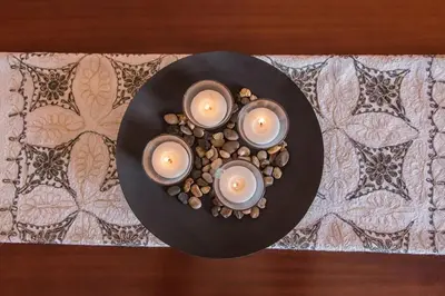 a black plate with three candles on a table at Sunny & Spacious 2BD apt near Acropolis in Athens