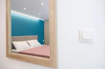 a mirror reflection of a bed in a room at Debbie's cozy 2bdr - 2bth apt near Acropolis in Athens