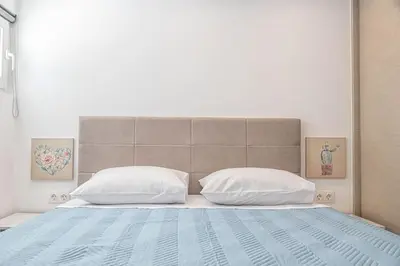 a bedroom with a large bed with two pillows at Debbie's cozy 2bdr - 2bth apt near Acropolis in Athens
