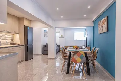 a kitchen and dining room with a table and chairs at Debbie's cozy 2bdr - 2bth apt near Acropolis in Athens