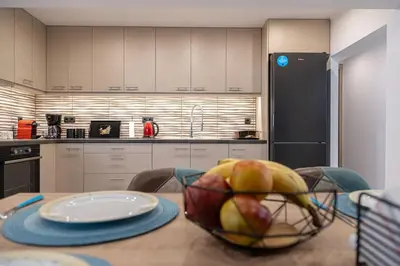 a kitchen with a bowl of fruit on a table at Debbie's cozy 2bdr - 2bth apt near Acropolis in Athens