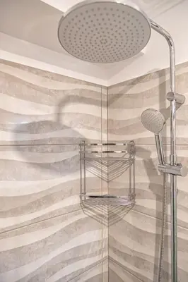 a bathroom with a shower with a shower head at Debbie's cozy 2bdr - 2bth apt near Acropolis in Athens