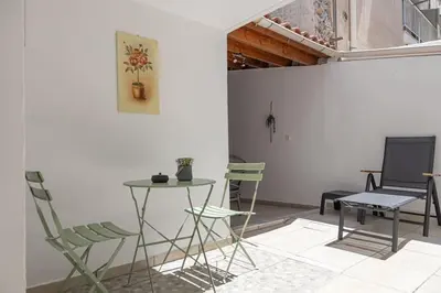 a room with chairs and a table and a table and chairs at Debbie's cozy 2bdr - 2bth apt near Acropolis in Athens