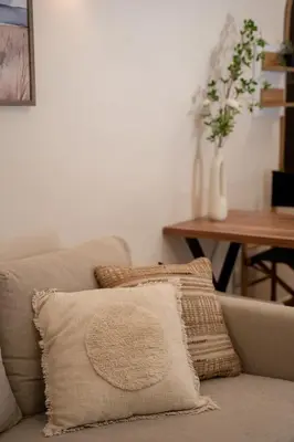 a couch with two pillows on it in a living room at Meraki Koukaki by A&D Properties in Athens