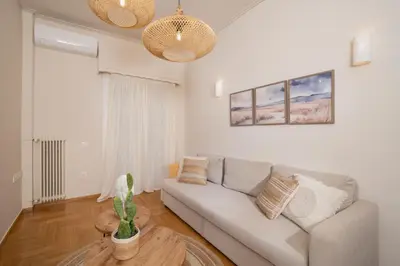 a living room with a couch and a table at Meraki Koukaki by A&D Properties in Athens
