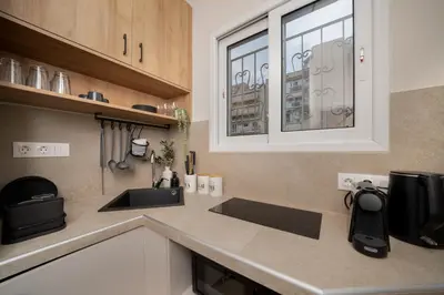 a kitchen with a sink and a microwave at Meraki Koukaki by A&D Properties in Athens
