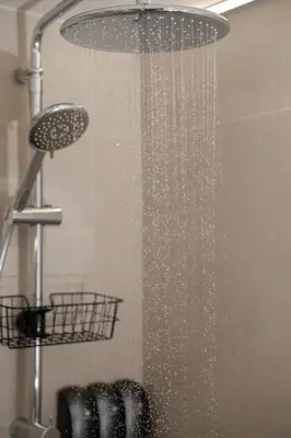 a shower in a bathroom with a shower head at Meraki Koukaki by A&D Properties in Athens