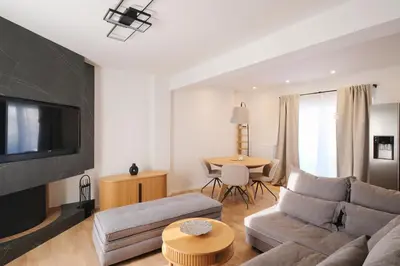 a living room with a couch and a tv and a table at Tyto Alba Habitat in Athens
