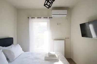 a bedroom with a bed with two towels on it at Tyto Alba Habitat in Athens