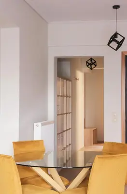 a dining room with a glass table and chairs at Tyto Alba Habitat in Athens