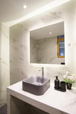 a bathroom with a sink and a mirror at Syntagma Hotel Style Luxury in Athens