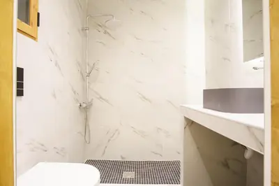 a white bathroom with a shower and a toilet at Syntagma Hotel Style Luxury in Athens