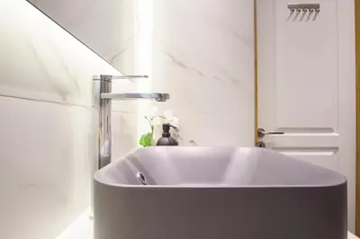 a sink with a faucet in a bathroom at Syntagma Hotel Style Luxury in Athens